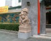 Close-up view of the lion guardian on the right side of the main gate